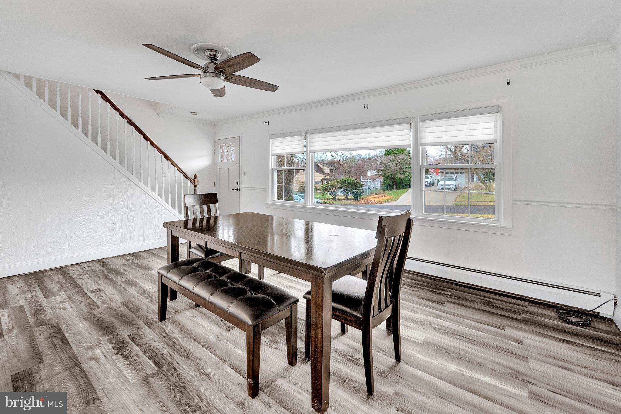6 Unity Turn Levittown, PA 19056 - Photo 10 of 50 a dining room with wooden floor a chandelier with a glass table and chairs
