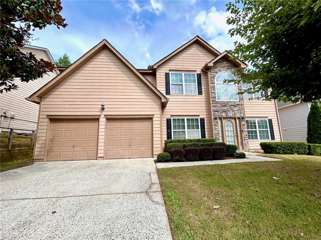1325 Grey Rock Way Suwanee, GA 30024 - Photo 1 of 1 a front view of a house with a yard and garage