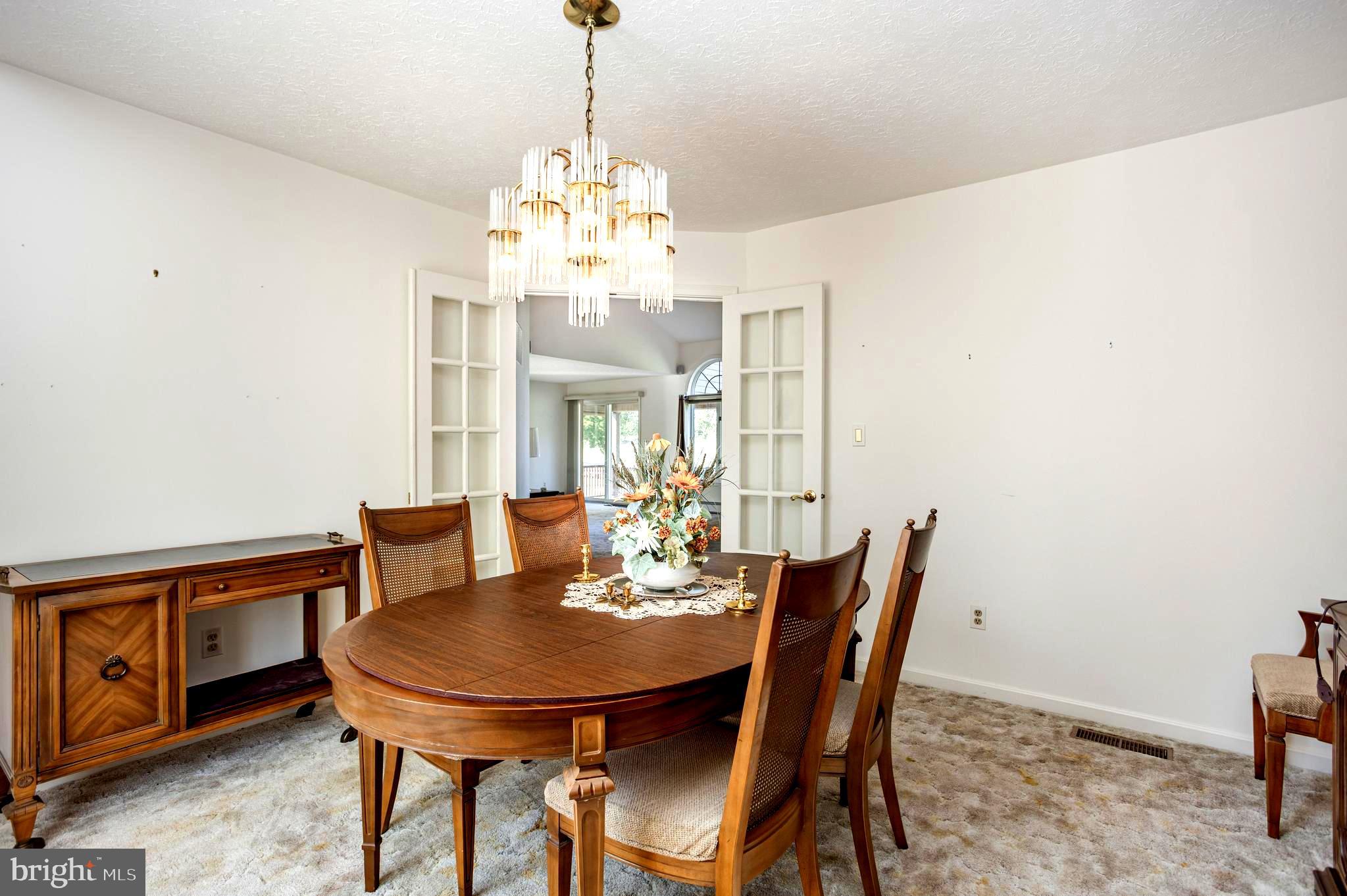 7252 Meadow Lane Baltimore, MD 21222 - Photo 14 of 80 a view of a dining room with furniture a chandelier and wooden floor