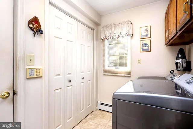 an empty room with fan and windows