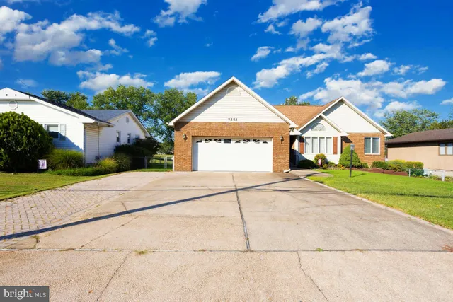 a dining room with furniture a chandelier and wooden floor