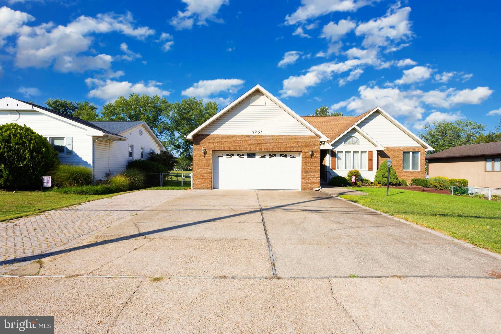 7252 Meadow Lane Baltimore, MD 21222 - Photo 2 of 80 a front view of a house with a yard and garage