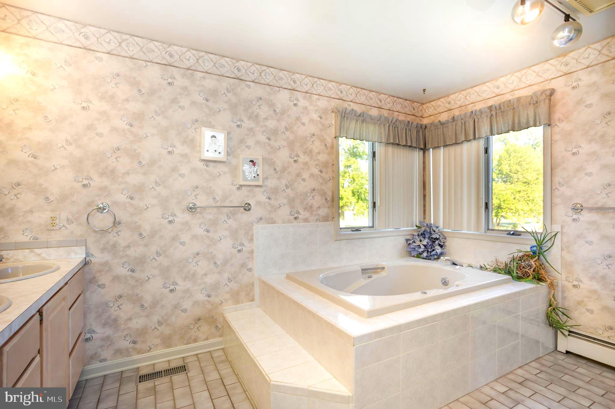 7252 Meadow Lane Baltimore, MD 21222 - Photo 22 of 80 a white bath tub sitting in a bathroom next to a window