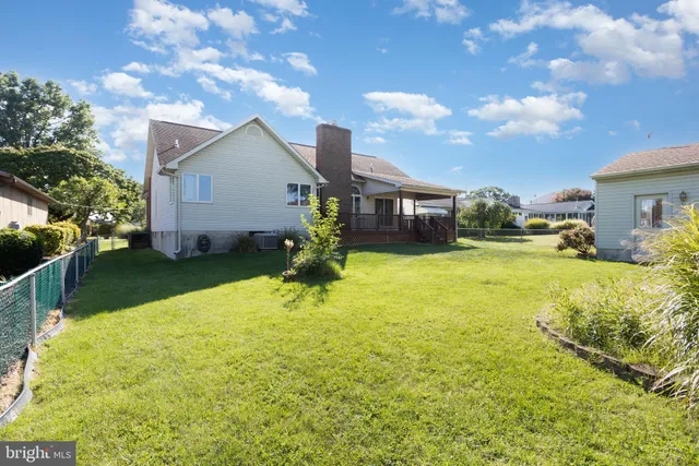 a view of a house with a yard and sitting area