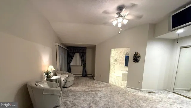 a lobby with furniture and a flat screen tv