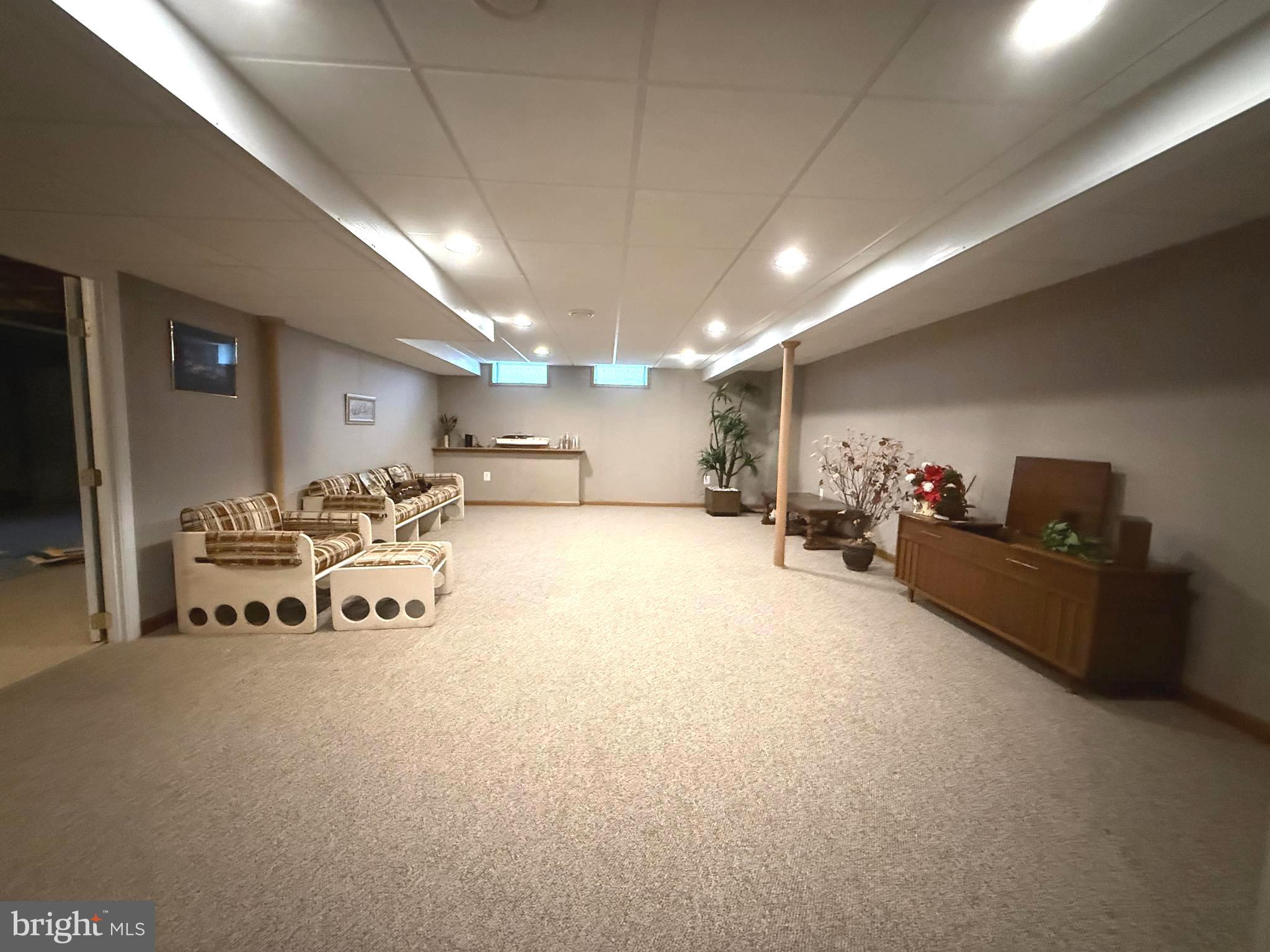 7252 Meadow Lane Baltimore, MD 21222 - Photo 72 of 80 a lobby with furniture and a flat screen tv