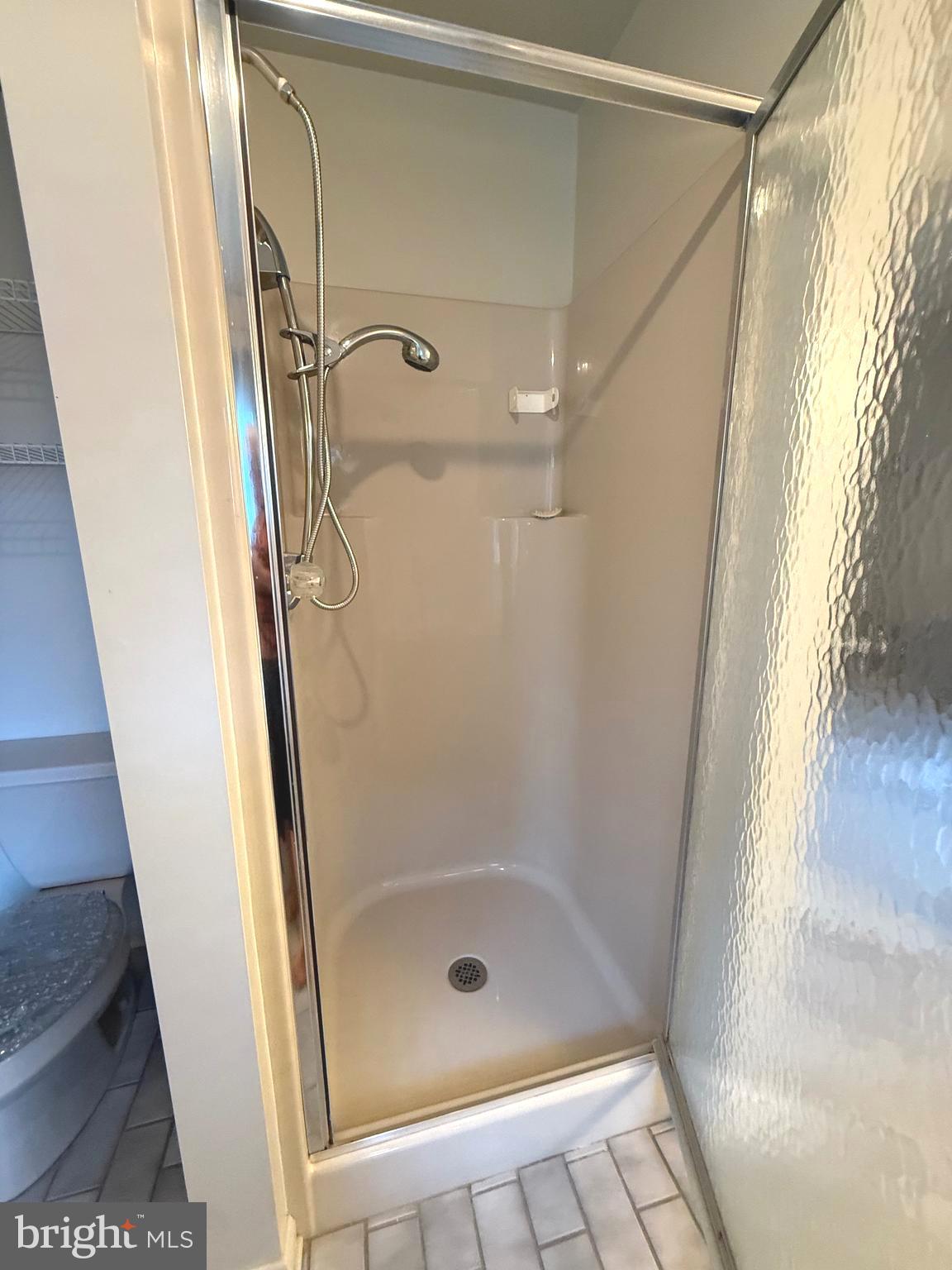 7252 Meadow Lane Baltimore, MD 21222 - Photo 77 of 80 a bathroom with a glass shower door