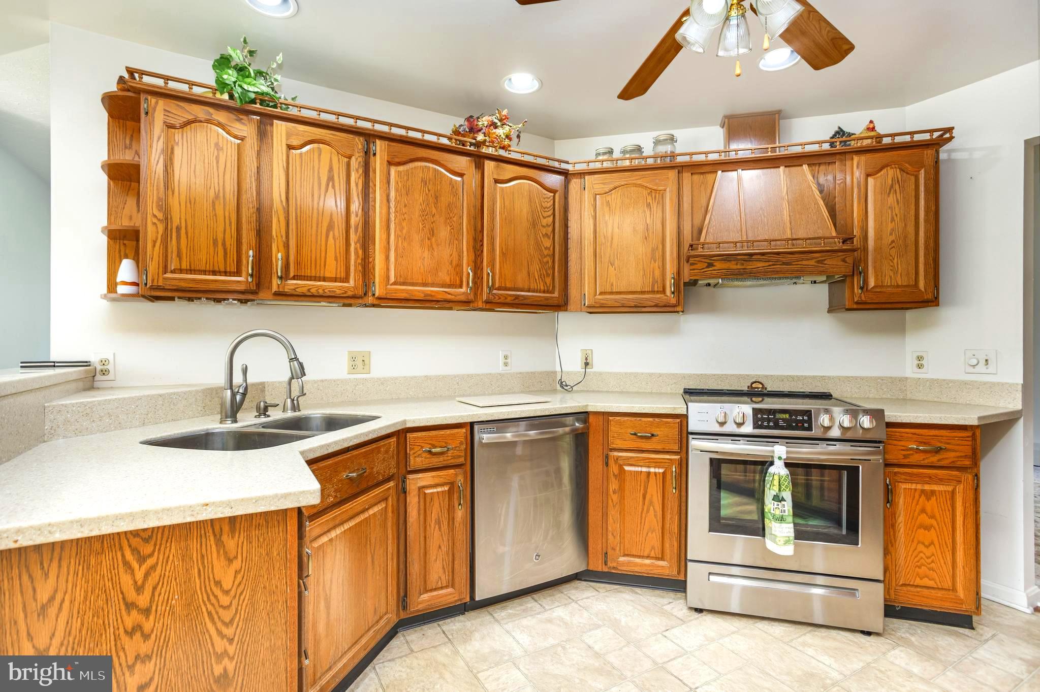 7252 Meadow Lane Baltimore, MD 21222 - Photo 10 of 80 a kitchen with stainless steel appliances granite countertop a stove a sink and a microwave