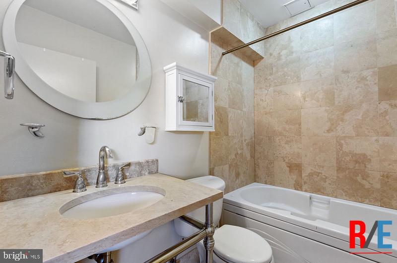 815 King Street, Unit 4E Alexandria, VA 22314 - Photo 15 of 27 a bathroom with a sink and a mirror