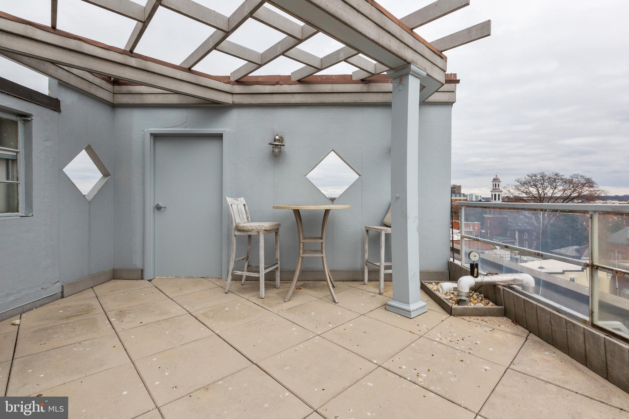 815 King Street, Unit 4E Alexandria, VA 22314 - Photo 22 of 27 a view of a chairs and bench in the roof of a building