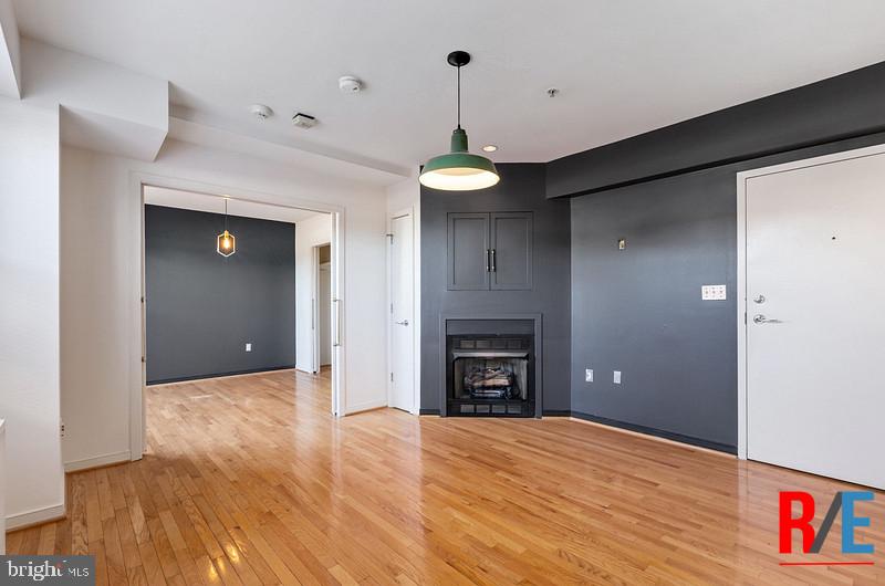 815 King Street, Unit 4E Alexandria, VA 22314 - Photo 7 of 27 a view of empty room with a fireplace and wooden floor