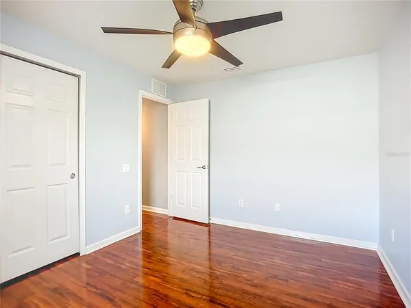 a view of empty room with wooden floor