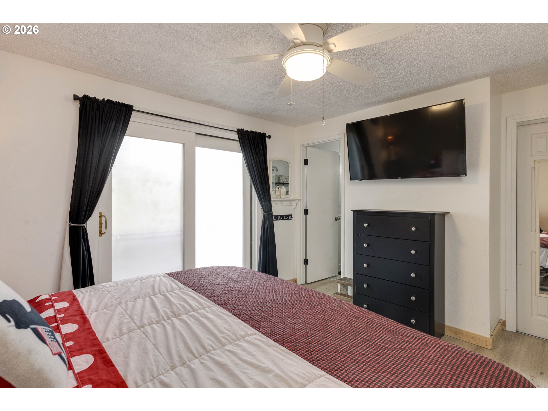 18430 Southwest Broad Oak Boulevard Aloha, OR 97007 - Photo 12 of 32 a bedroom with a bed and a flat screen tv