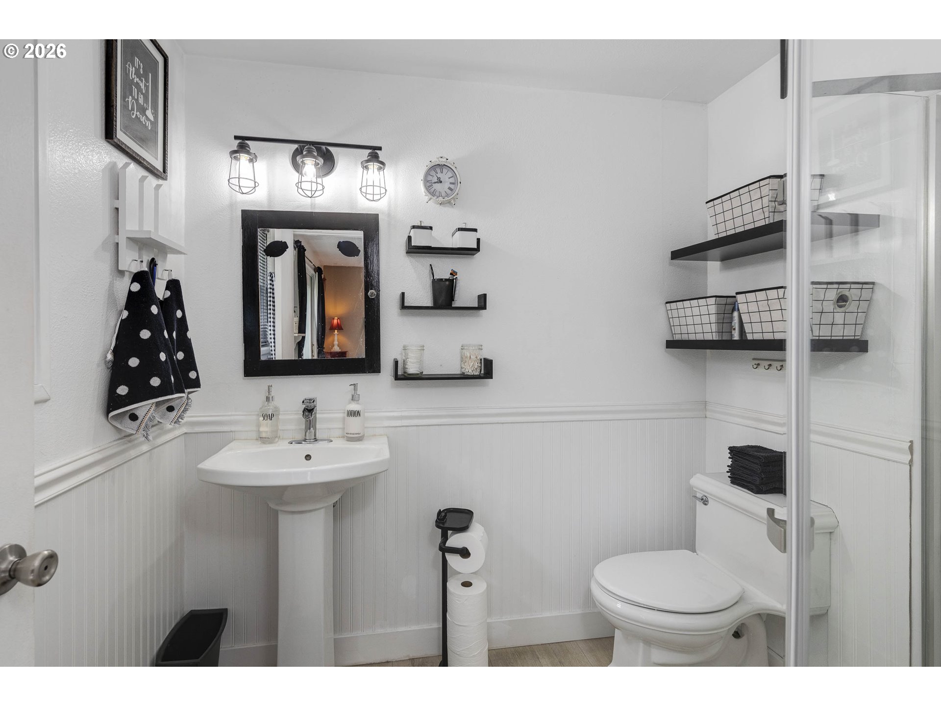 18430 Southwest Broad Oak Boulevard Aloha, OR 97007 - Photo 13 of 32 a bathroom with a toilet sink and mirror