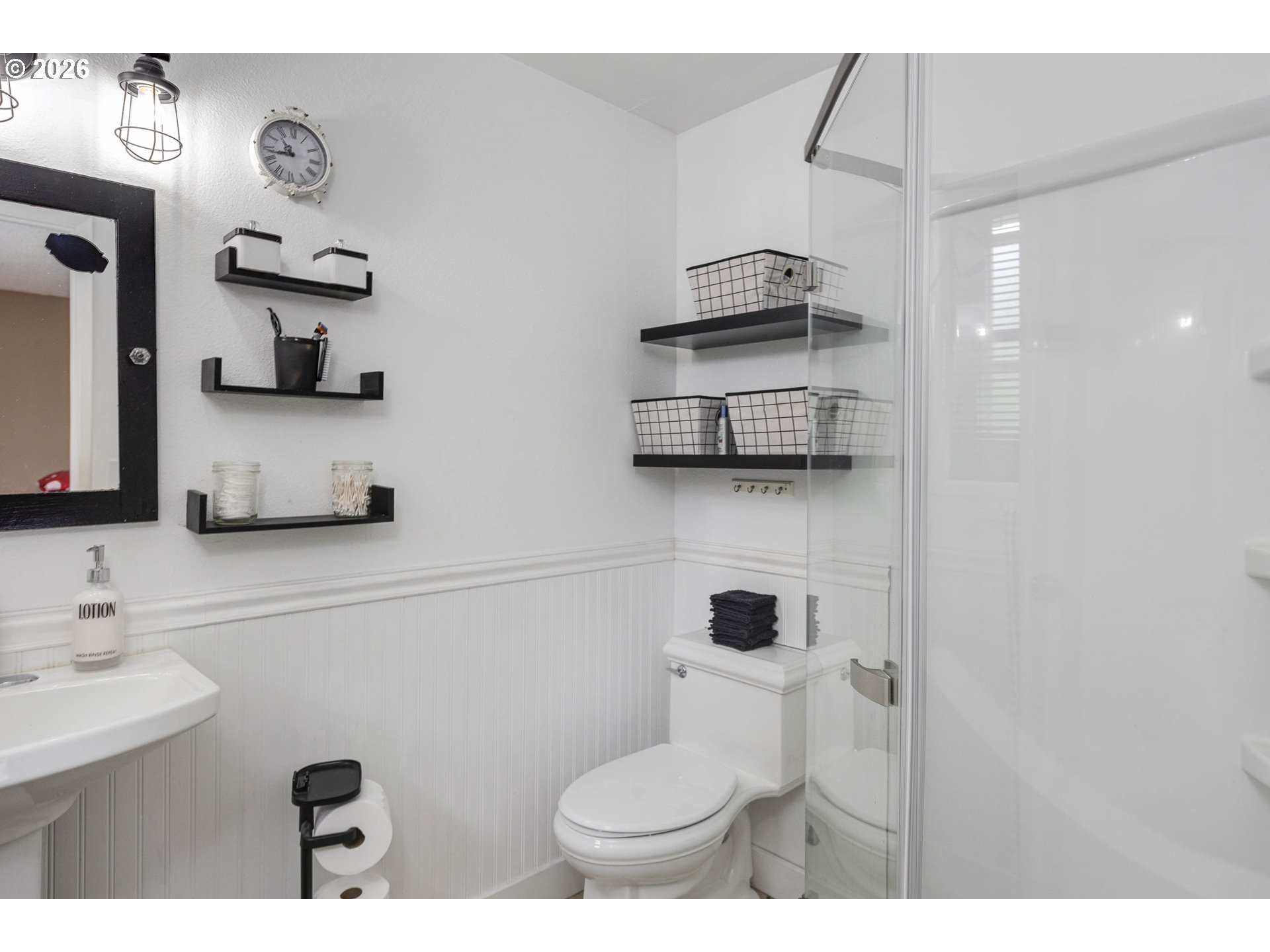 18430 Southwest Broad Oak Boulevard Aloha, OR 97007 - Photo 14 of 32 a bathroom with a toilet sink and mirror