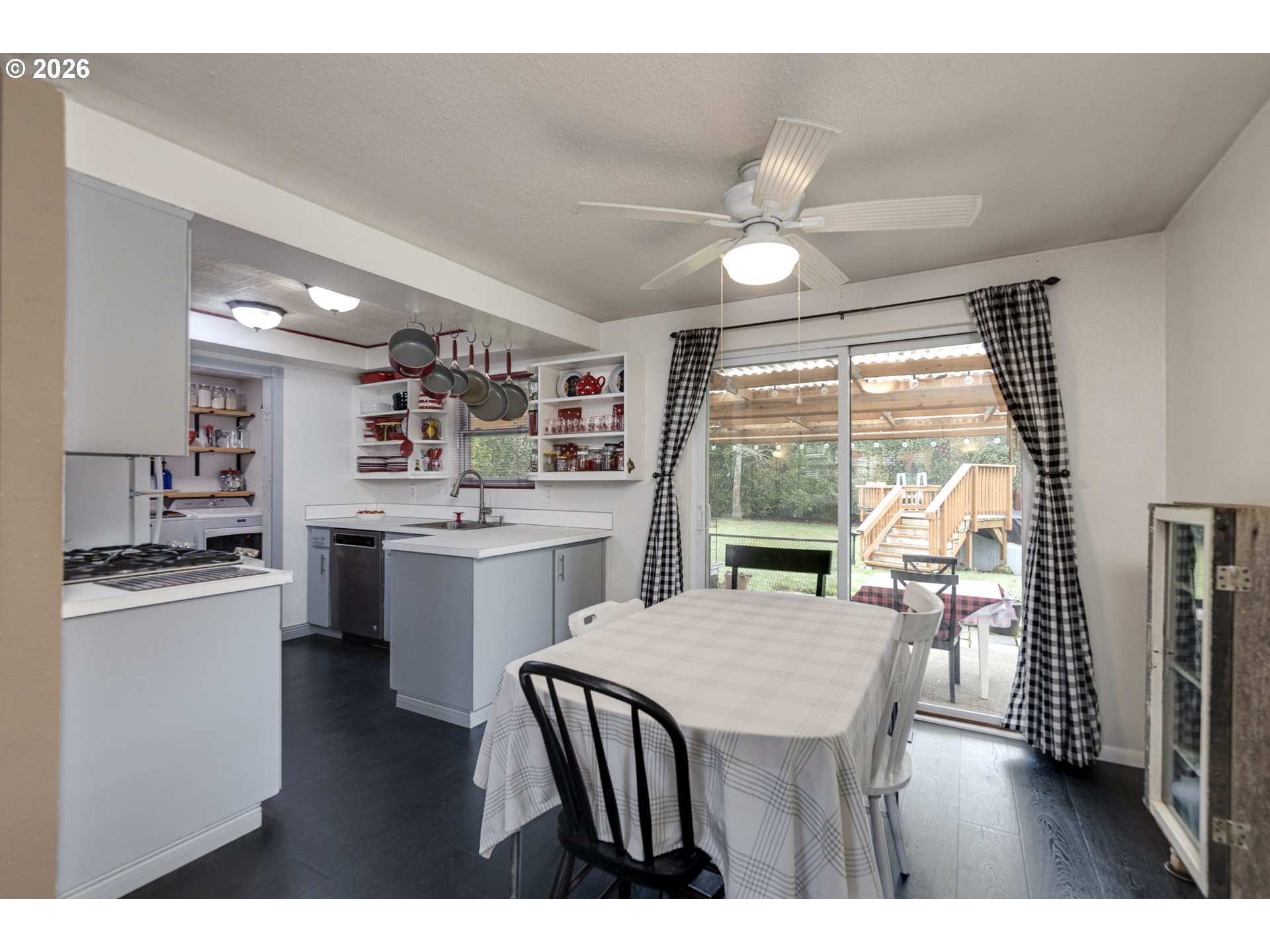 18430 Southwest Broad Oak Boulevard Aloha, OR 97007 - Photo 17 of 32 a kitchen with a table chairs refrigerator and cabinets