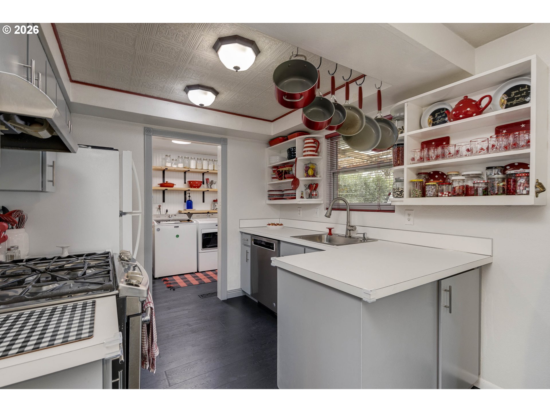 18430 Southwest Broad Oak Boulevard Aloha, OR 97007 - Photo 20 of 32 a kitchen that has a lot of cabinets a sink and a stove