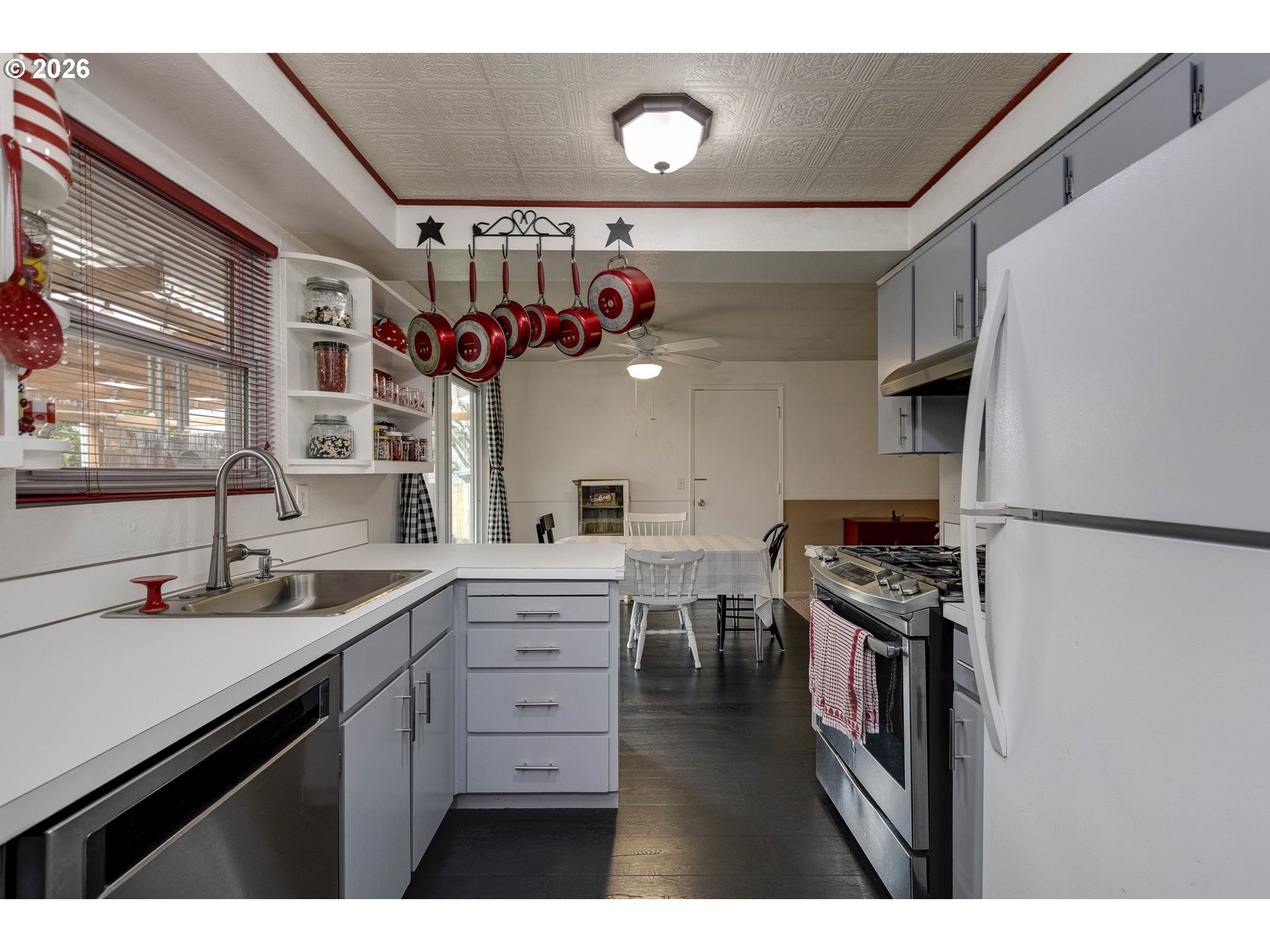 18430 Southwest Broad Oak Boulevard Aloha, OR 97007 - Photo 24 of 32 a kitchen with stainless steel appliances a sink stove and cabinets