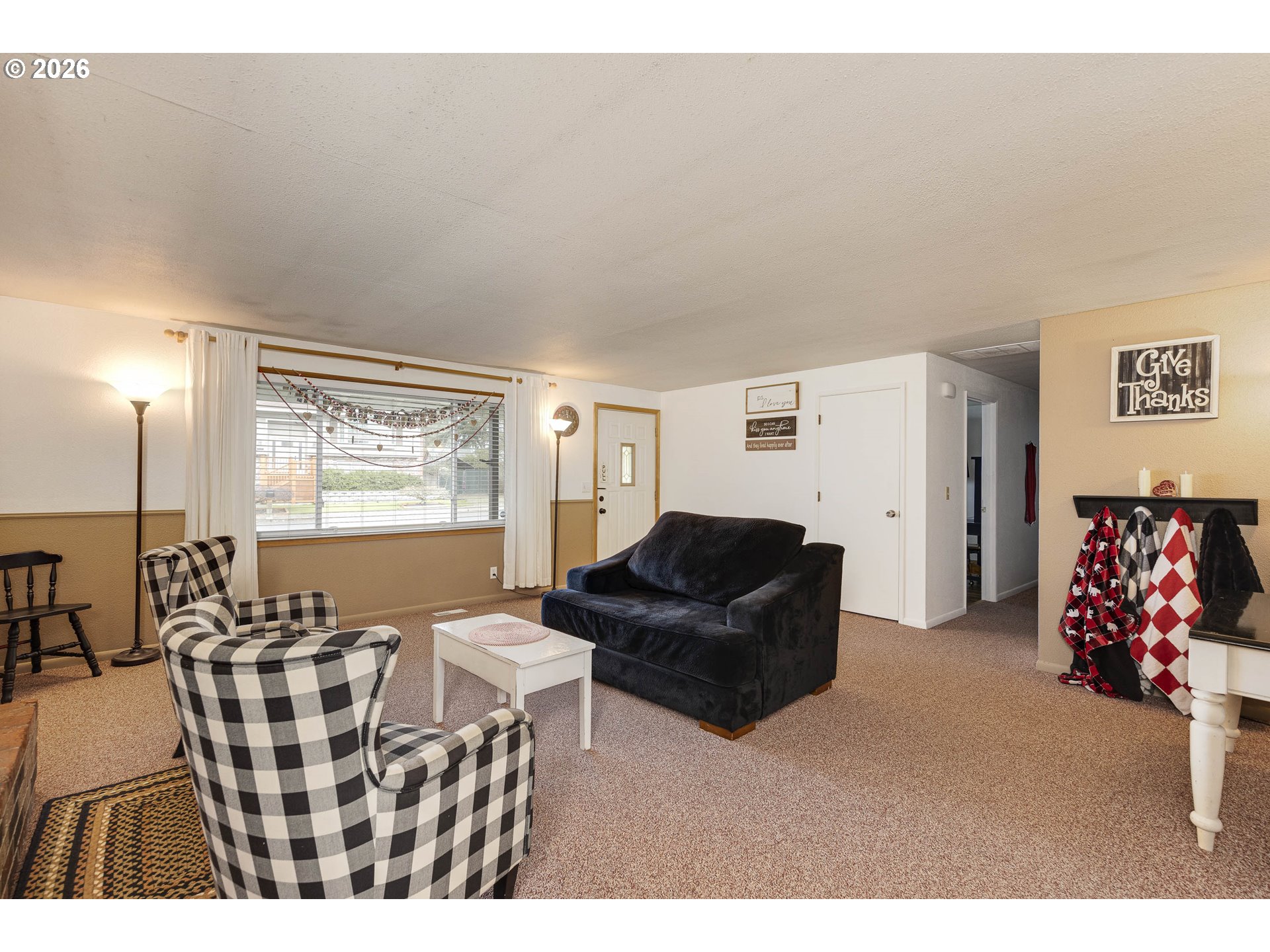 18430 Southwest Broad Oak Boulevard Aloha, OR 97007 - Photo 8 of 32 a living room with furniture and a large window