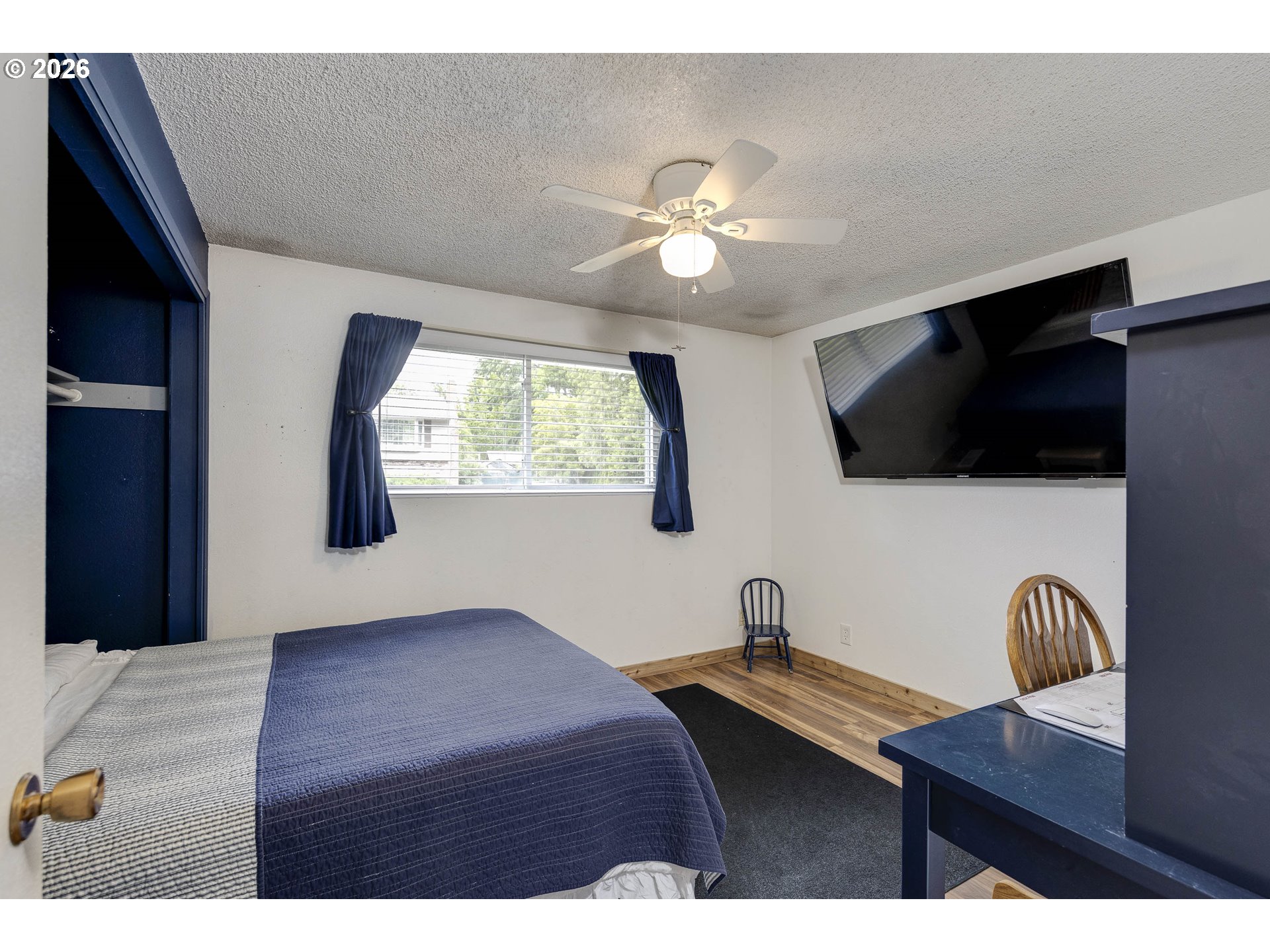 18430 Southwest Broad Oak Boulevard Aloha, OR 97007 - Photo 9 of 32 a bedroom with a bed and a flat screen tv