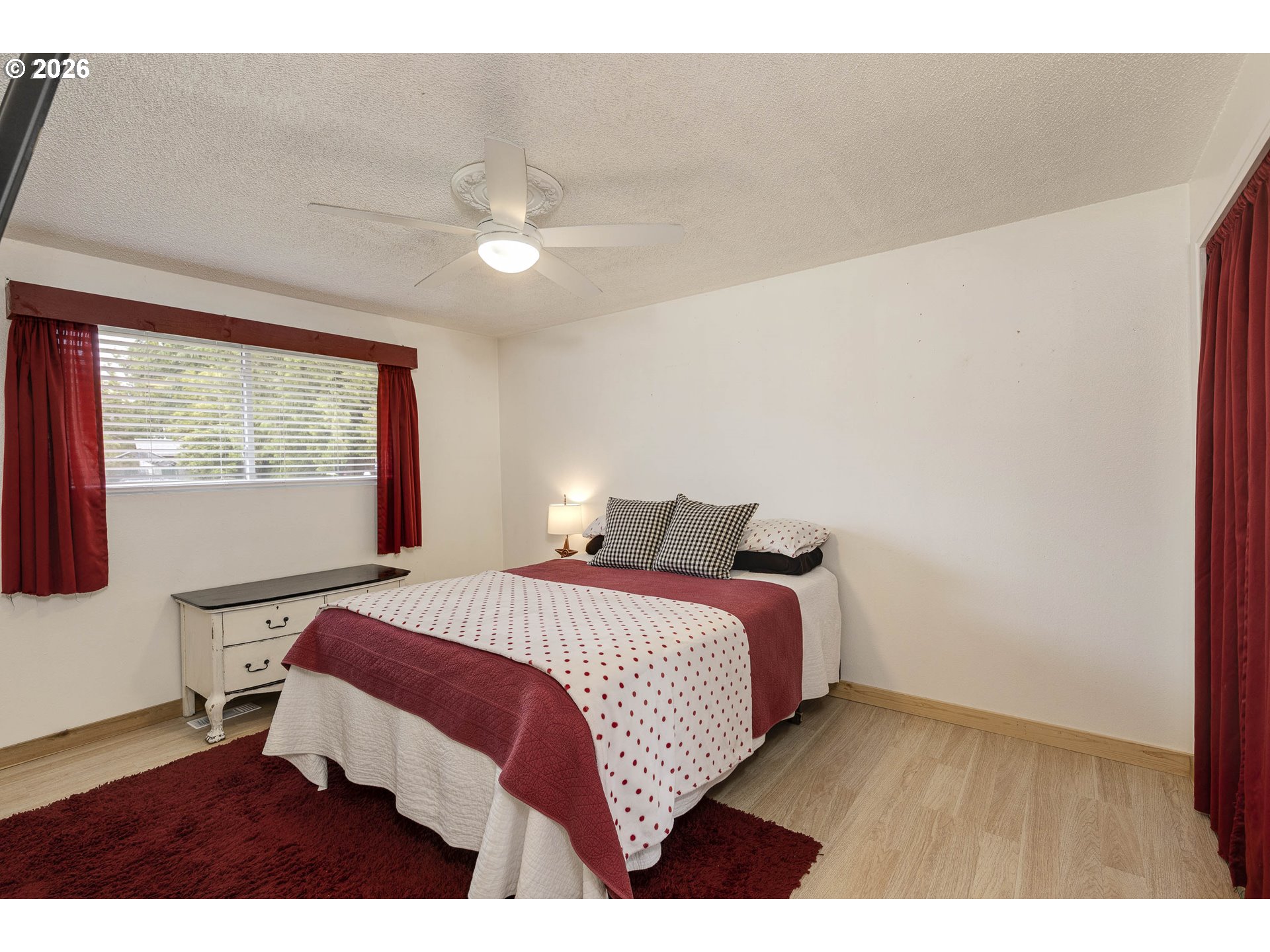 18430 Southwest Broad Oak Boulevard Aloha, OR 97007 - Photo 10 of 32 a bedroom with a bed lamp and a large window