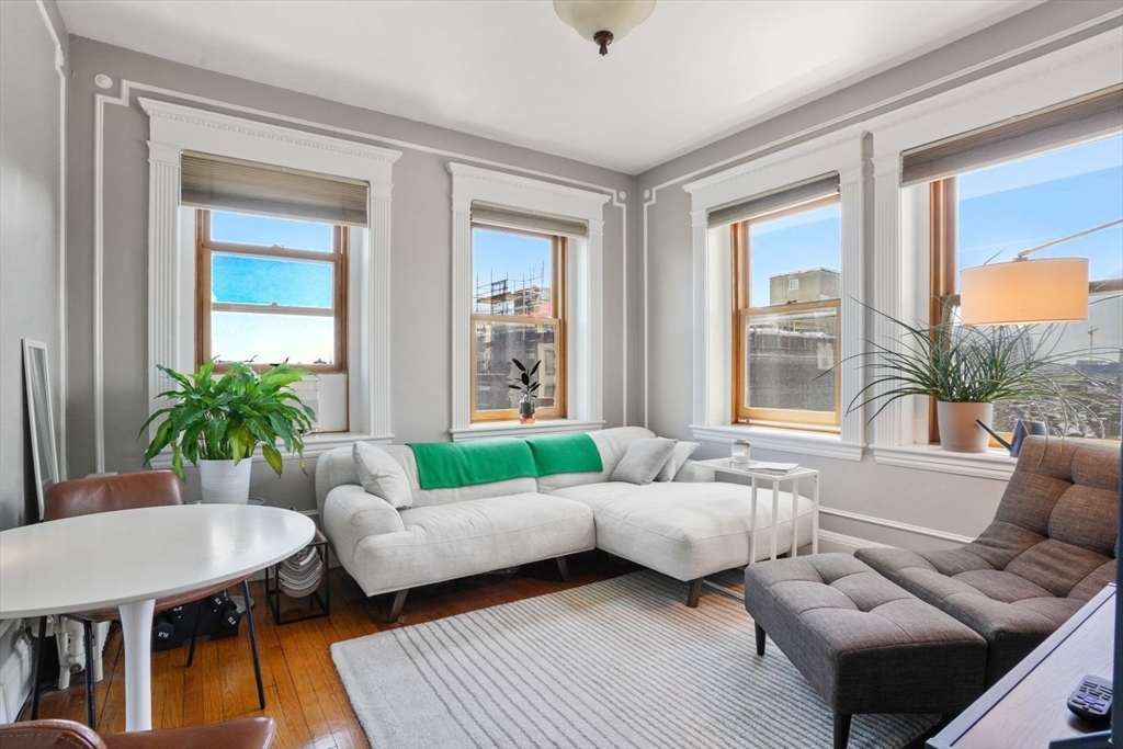 8 Garrison Street, Unit 706 Boston, MA 02116 - Photo 1 of 14 a living room with furniture and a large window