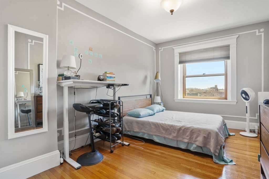 8 Garrison Street, Unit 706 Boston, MA 02116 - Photo 4 of 14 a bedroom with a bed and wooden floor