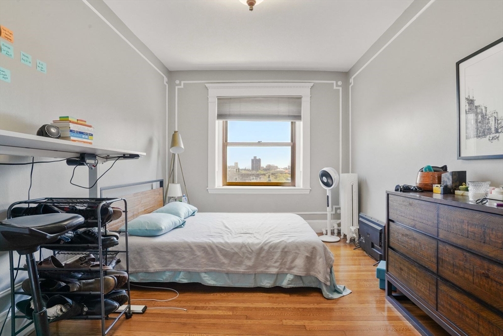 8 Garrison Street, Unit 706 Boston, MA 02116 - Photo 5 of 14 a bedroom with a bed and wooden floor