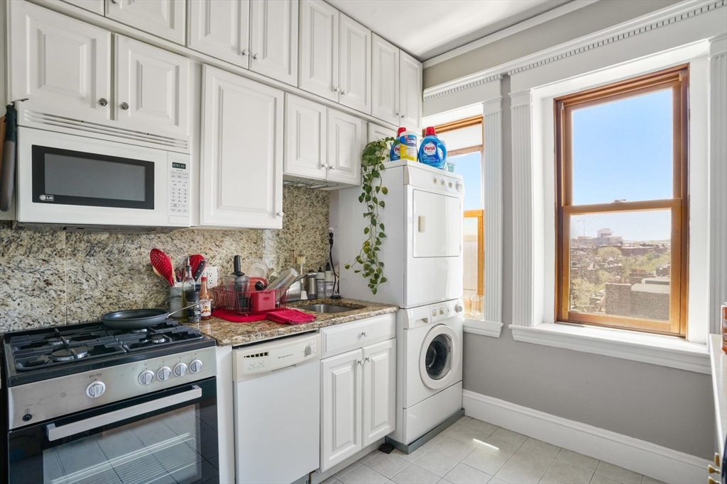 8 Garrison Street, Unit 706 Boston, MA 02116 - Photo 8 of 14 a kitchen with stainless steel appliances granite countertop a stove and a refrigerator