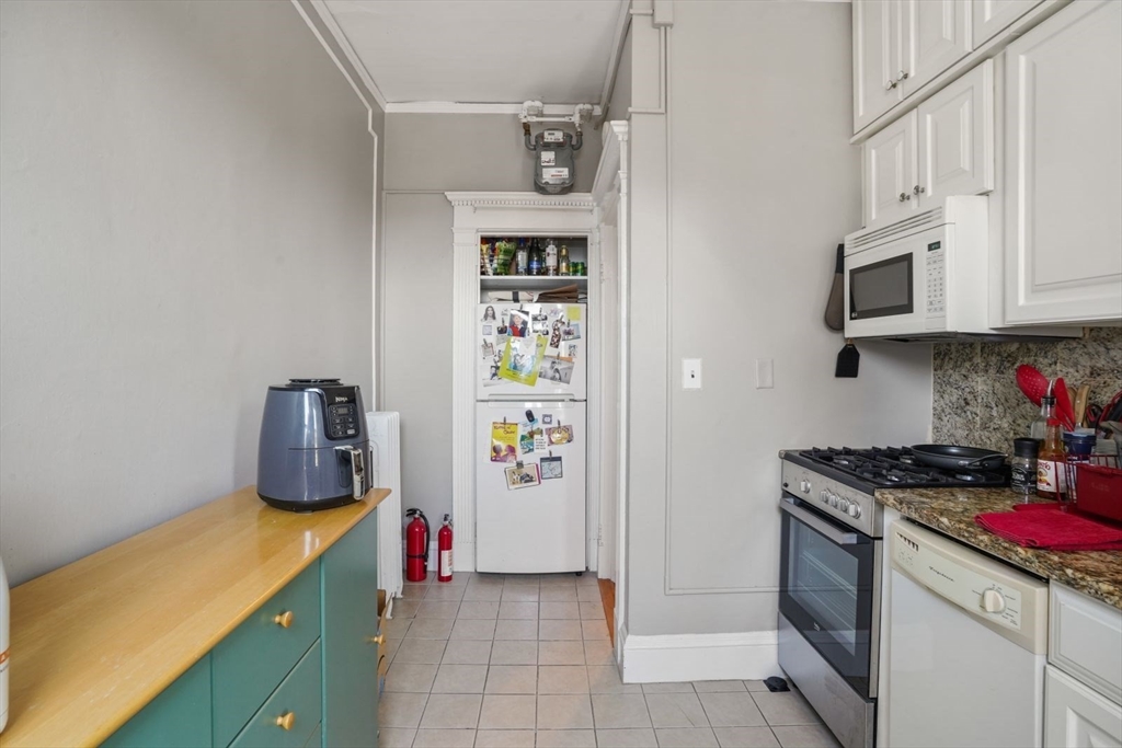 8 Garrison Street, Unit 706 Boston, MA 02116 - Photo 10 of 14 a kitchen with stainless steel appliances granite countertop a stove and cabinets