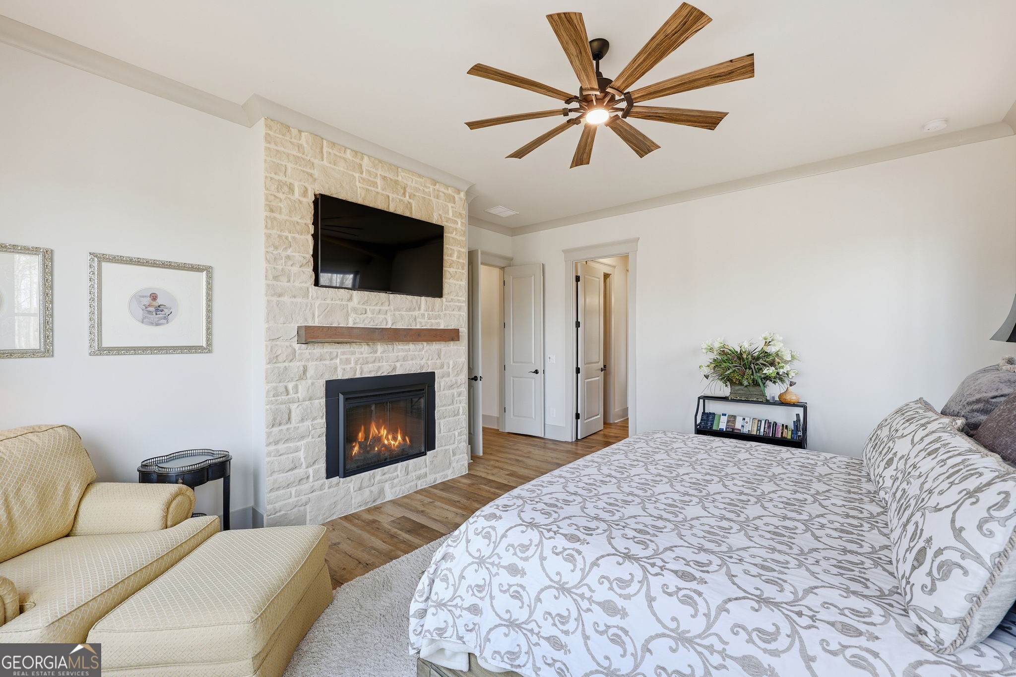 1282 Dean Hill Road Southeast Monroe, GA 30655 - Photo 41 of 58 a bedroom with a large bed and a fireplace