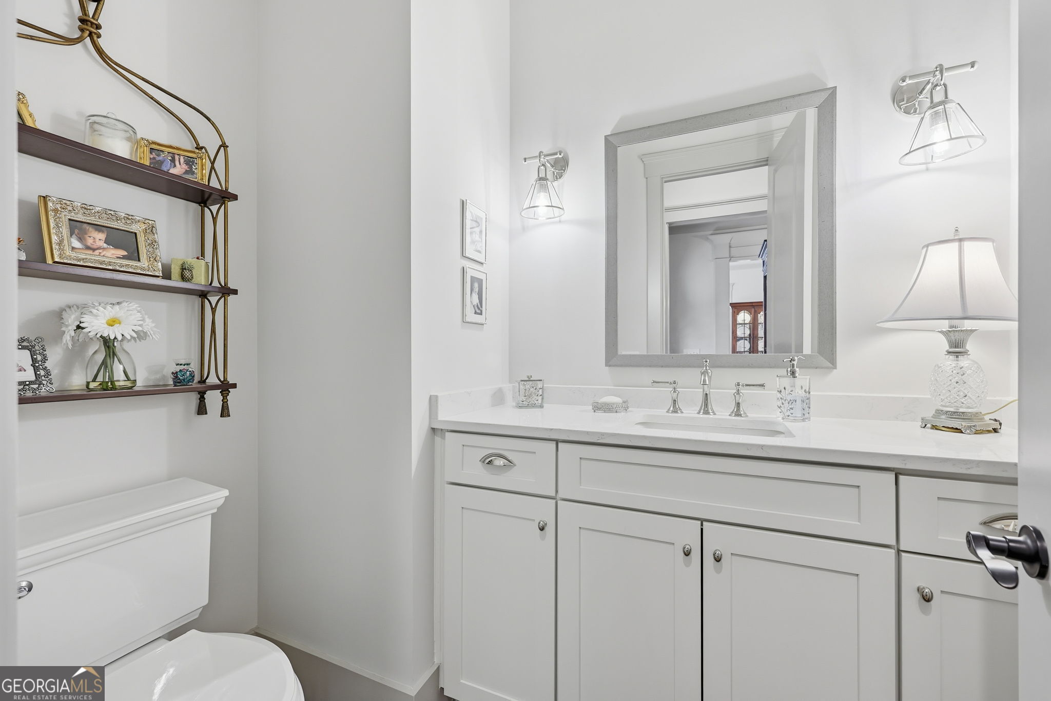 1282 Dean Hill Road Southeast Monroe, GA 30655 - Photo 47 of 58 a bathroom with a toilet sink and mirror