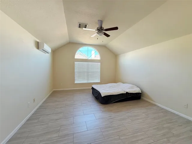 a living room with a bed furniture and a window