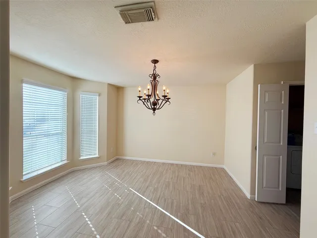 a view of a room with wooden floor cabinet and windows