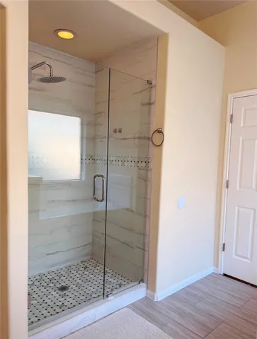 a bathroom with a shower and a sink