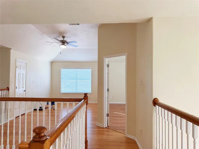 a view of staircase with railing and white walls
