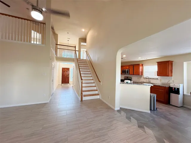 a view of a kitchen with furniture and wooden floor