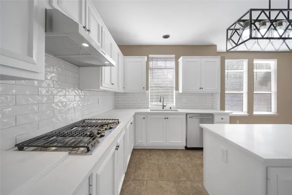 a kitchen with a stove a sink and a refrigerator