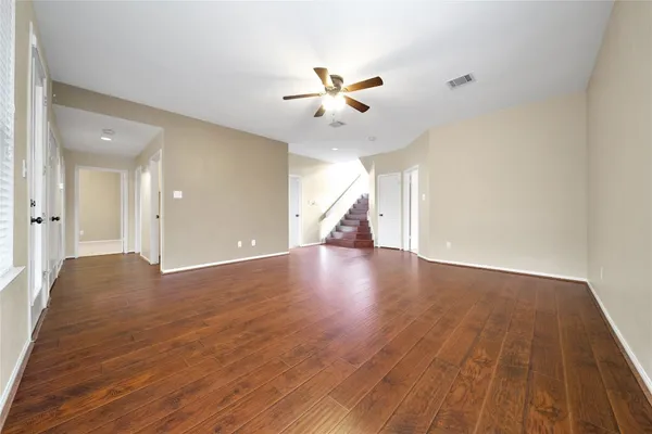 wooden floor in an empty room with a window