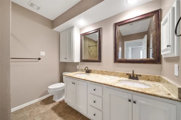 an empty room with closet and fan