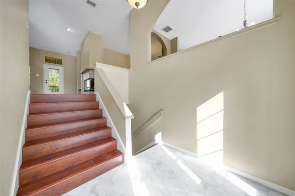 a view of entryway and hall with wooden floor
