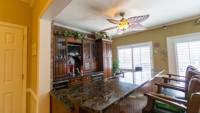 a bathroom with a granite countertop sink mirror and bathtub