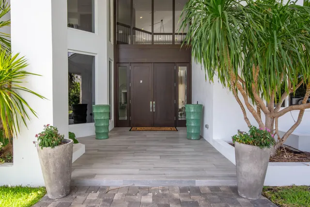 a living room with furniture a flat screen tv and a large window