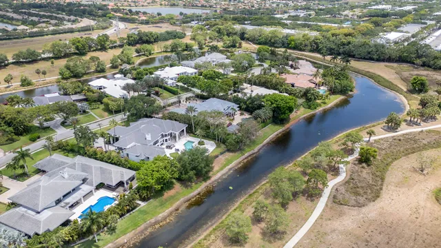 a view of a swimming pool with a patio and a yard