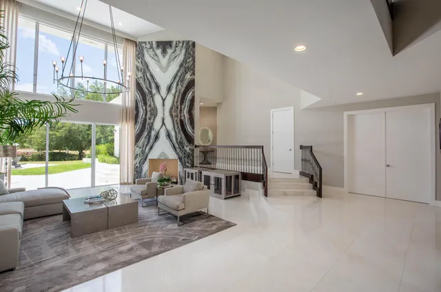a kitchen with a table chairs stove and white cabinets