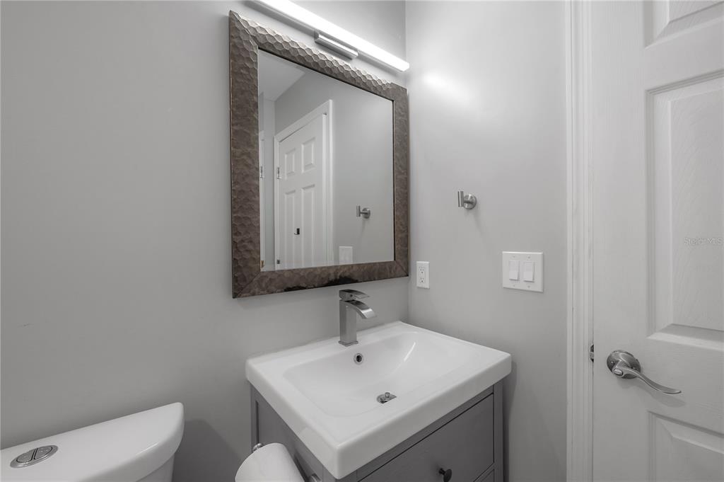 2341 West Chestnut Street Tampa, FL 33607 - Photo 28 of 42 a bathroom with a sink a toilet and mirror
