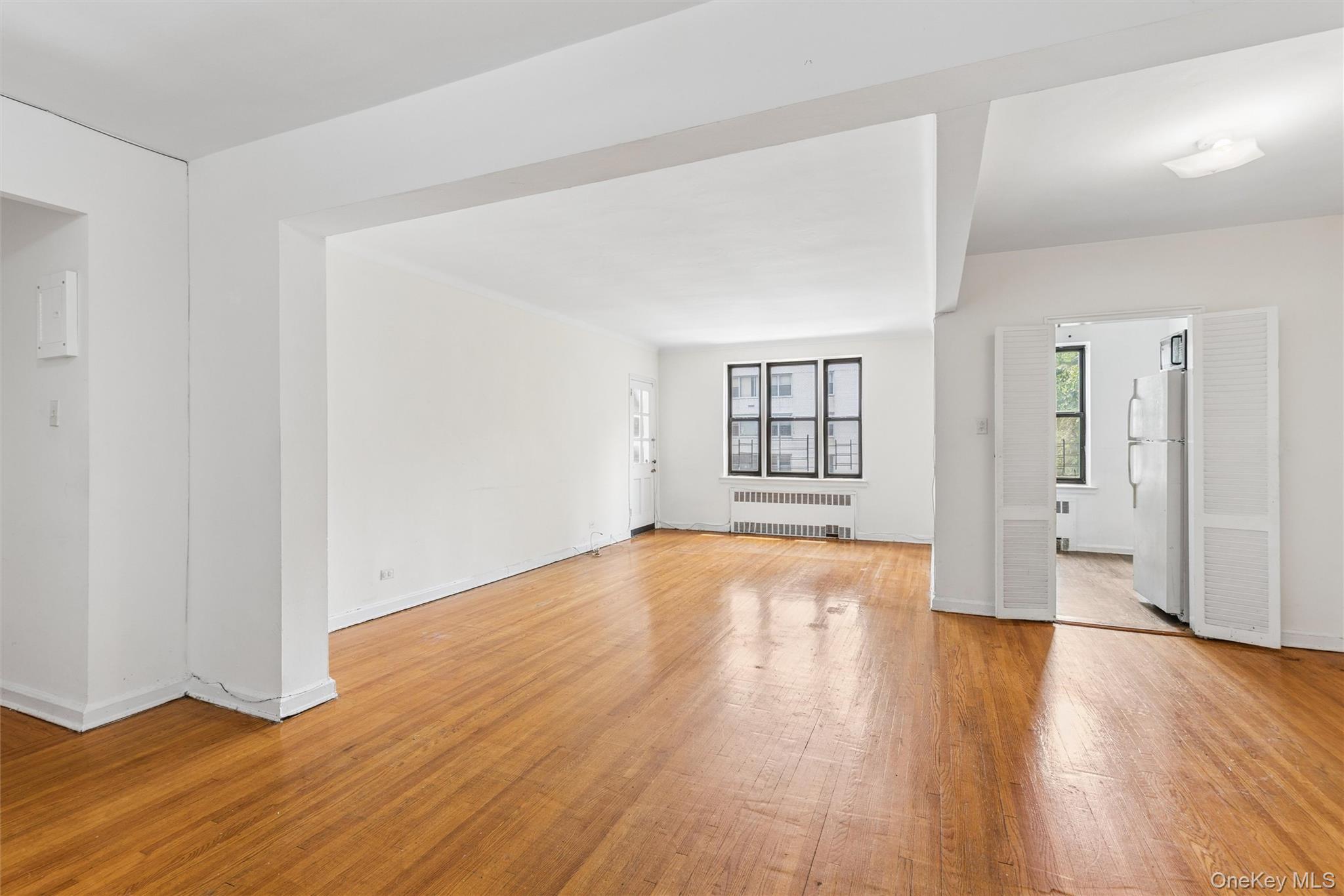 123-35 82nd Road, Unit 5U Queens, NY 11415 - Photo 2 of 11 View from foyer to living room, dining and kitchen