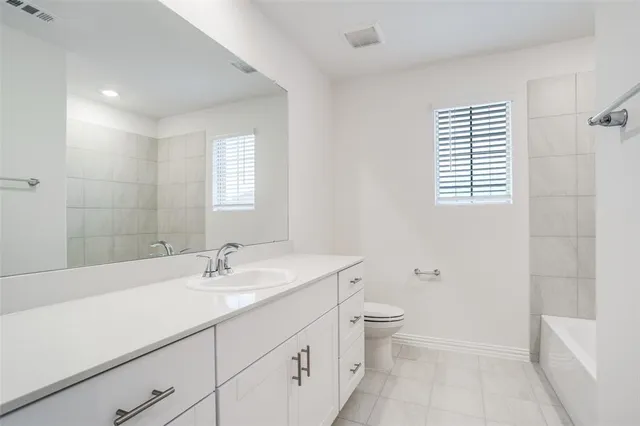 an empty room with a window and a ceiling fan