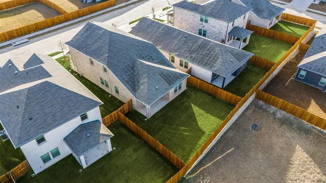 an aerial view of a house with a big yard
