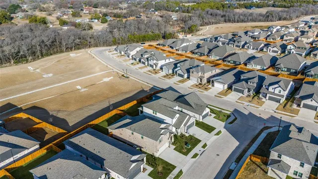 a view of an empty room and kitchen view